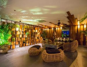 a living room with a table and chairs and books at Luxurious Beachfront Pattaya in North Pattaya