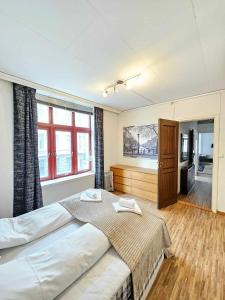 a bedroom with a large bed and a large window at Inner City Center in Bergen