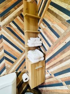 a bathroom with a wooden ceiling with towels at Villa Panorama in Montego Bay
