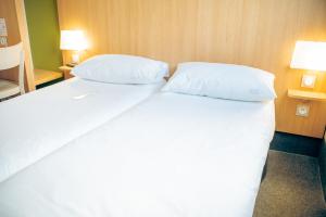 Postel nebo postele na pokoji v ubytování B&B HOTEL Metz Est Technopole Pôle Santé