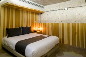 Una cama o camas en una habitación de Hotel Carlota