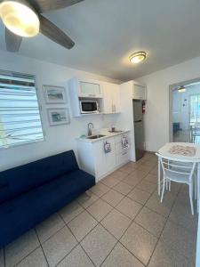 a living room with a blue couch and a table at Beach Front Apartments Seven Seas in Fajardo