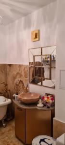 a bathroom with a sink and a counter with a sink at Apartament Stephen in Constanţa +30 photos