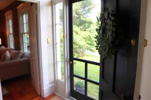 an open door with a view of a living room at Hillside Haven: Luxe Farm Escape - 5BR-2 King Beds in Swanzey