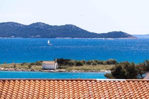 a view of the ocean from the roof of a house at Apartments & Room Diana in Pakoštane