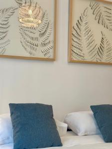 two framed pictures on the wall above a bed at Rive Gauche - Studio Trouville in Trouville-sur-Mer