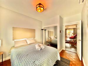 a bedroom with a bed with a white bedspread at The Only Backpacker's Inn in Toronto