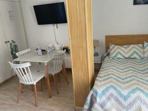 a bedroom with a table and chairs and a bed at Benalbeach loft in Benalmádena