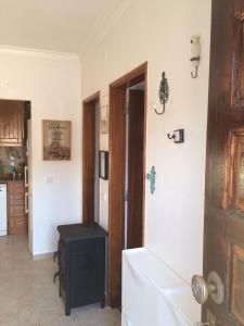 a room with a hallway with a door and a table at Caparica Holidays in Charneca