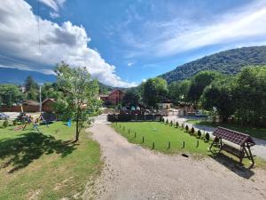 a park with a park bench and a playground at Casa ARRA in Bran
