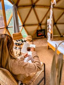 a woman sitting in a chair with a laptop in a yurt at Serenity Dome Sapanca in Sapanca