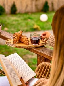 a plate of bread and a cup of tea and a book at Serenity Dome Sapanca in Sapanca