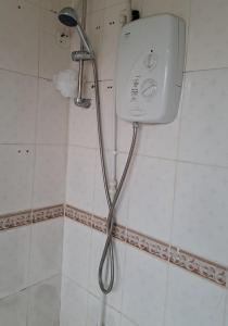 a shower in a bathroom with a shower head at Mfalme House, Ngoingwa Estate, 100 Metres from Thika-Mangu Rd, Close to Thika City Centre - Free Parking, Fast Wi-Fi, Smart TV, 2 Bedrooms Perfect for a Family of 2-4 Members in Thika