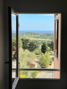 a window in a room with a view of a field at "L'Horizon Bleu" Vue mer - 2 chambres - Parking - Piscine in La Croix-Valmer