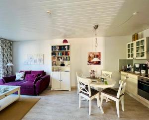 a living room with a purple couch and a table at Lodge 2 Bad Harzburg in Bad Harzburg