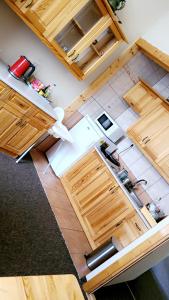an overhead view of a kitchen with wooden cabinets at Willa nad Potokiem in Zakopane