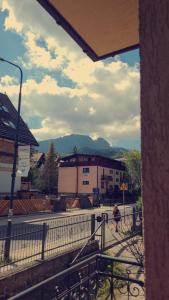a person walking down a street in front of a building at Willa nad Potokiem in Zakopane