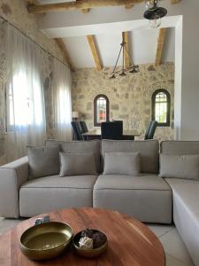 a living room with a couch and a table at Windy Inns ( Maistros I ) in Vouyiáton