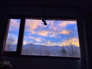 a window with a view of a cloudy sky at LA MULITA HUMAHUACA in Humahuaca