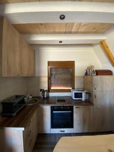 a kitchen with a stove and a microwave at Srce Zminice in Žabljak
