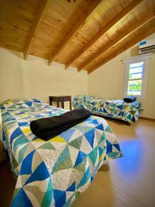 a bedroom with a bed and a couch in a room at brisas de villa gesell in Villa Gesell