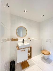 a bathroom with a toilet and a sink and a mirror at Canal View Stay Amsterdam in Amsterdam