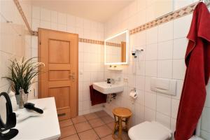 a bathroom with a toilet and a sink at Oewern Diek App 55 in Wustrow