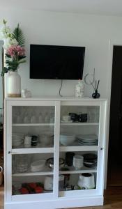 a white cabinet with a television on top of it at Entre Neige et Thermes in Brides-les-Bains