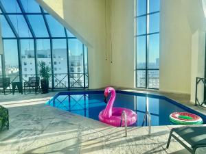 a pink flamingo in a swimming pool in a building at Oscar Freire Hotel RDS Jardins in São Paulo