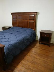 a bedroom with a bed and two night stands at Quiet 3 bed with fenced yard in Columbus