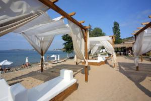 a row of white beds on a beach at Sea Bliss Retreat -Santa Marina - Sozopol in Sozopol