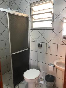a small bathroom with a toilet and a sink at Residêncial Beatríz in Florianópolis
