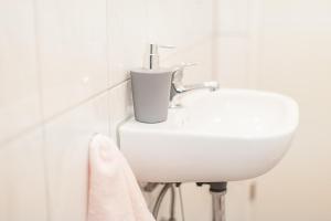 a white sink in a bathroom with a towel at DO One Bedroom Flat in Dortmund