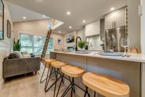 a kitchen with wooden stools and a counter with a bar at creekside Innsbrook in Whistler