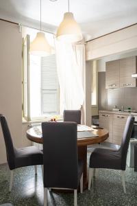 a kitchen with a dining room table and chairs at Casa vacanze nel centro storico di Fermo Happy Song in Fermo +22 photos