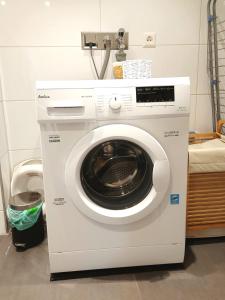 a white washing machine sitting in a room at FeWo Lichtblick in Mengen