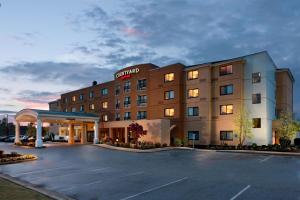 a hotel with a parking lot in front of it at Courtyard by Marriott Jackson in Jackson