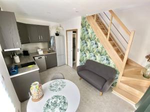 a kitchen and a living room with a couch and a table at Petite Maison indépendante. in Béziers