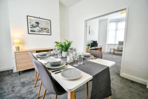 a dining room with a white table and chairs at Lister House in Hartlepool