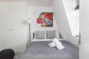 a bedroom with a bed with a painting on the wall at Cozy and Small Studio Zone 2 near Maida vale 6 in London