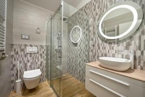 a bathroom with a sink and a toilet and a mirror at Apartmani Biserka in Mandre +19 photos