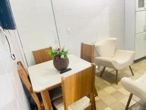 a room with a table with a vase of flowers on it at Apartamento em Boa Viagem in Recife