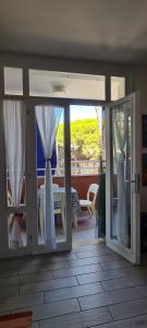 a sliding glass door with a view of a patio at La Casa del mare in Rosolina Mare