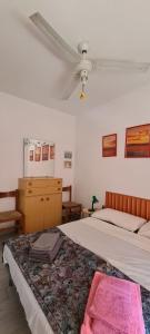 a bedroom with two beds with a pink blanket at La Casa del mare in Rosolina Mare