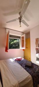 a bedroom with a bed with a ceiling fan at La Casa del mare in Rosolina Mare