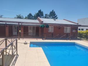a swimming pool in front of a house at El Desafío in Santa Ana