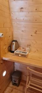a wooden shelf in a cabin with a kettle on it at Agriturismo Fattoria didattica Il Macereto in Fivizzano