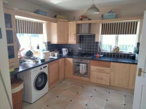 a kitchen with a washing machine and a washer at 19 Doran Close in Donegal