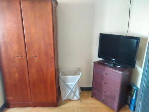 a television on a dresser next to a wooden cabinet at 19 Doran Close in Donegal