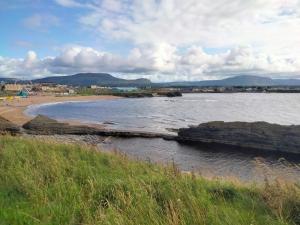 a body of water with a beach and a town at 19 Doran Close in Donegal
